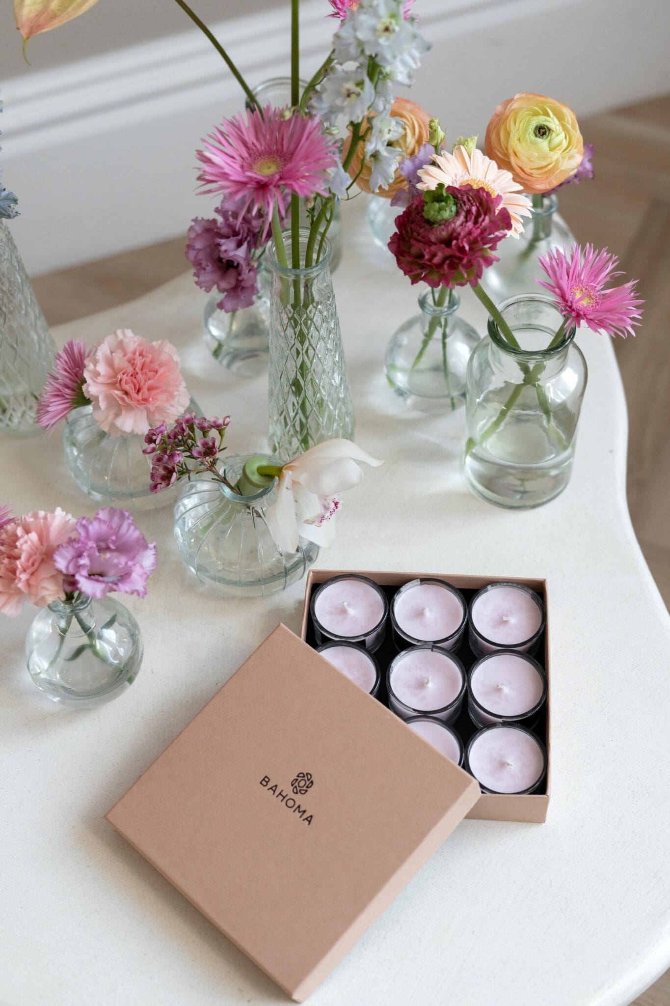 Velvet Peony & Cashmere Nine Lights Candle Set from the Alchemy Collection. Image showing open box with nine mini candles in light pink.
